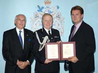 Mr Nelson (right) recieves his award from Sir Ian Blair and Carnegie chairman Angus Hogg. 