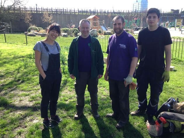 group of volunteers behind the acton green community herb garden