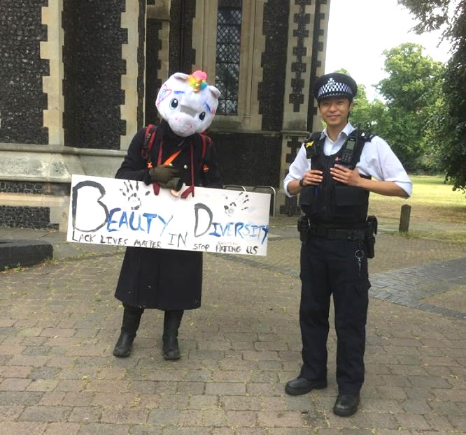 Anti-racism protestor with police officer on Turnham Green