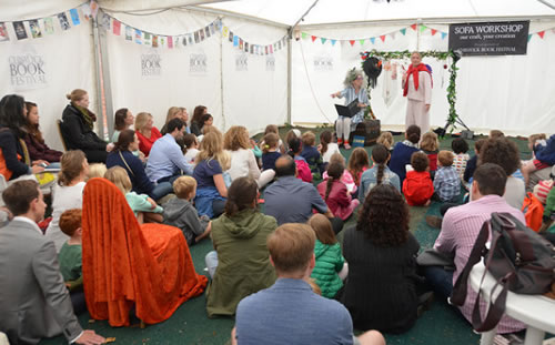 children listening to stories in a tent at the chiswick book festival