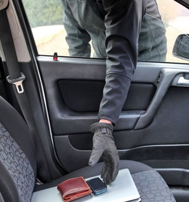 thief breaks into a car 