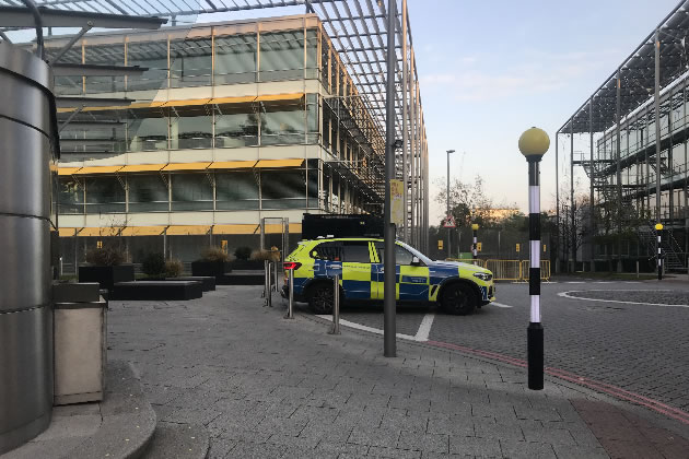 A police presence remains a constant in the office development
