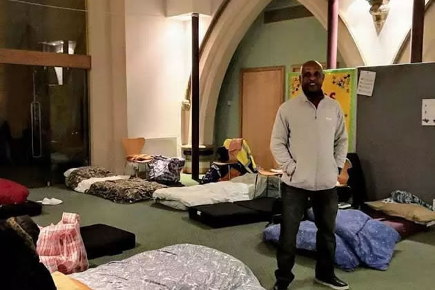 Cedric, a volunteer at the Church, with beds laid out for rough sleepers 