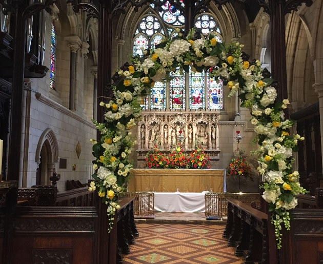 the main altar decorated with flowers at st nicks 