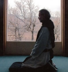 person kneeling in prayer