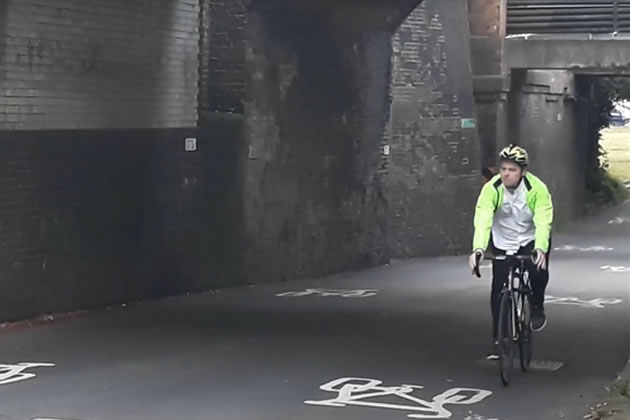 Cllr Peter Mason cycling through the underpass