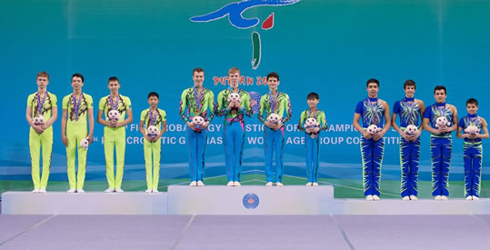 Image of the Chiswick finalists in China on the podium in chinese acrobatics competition 