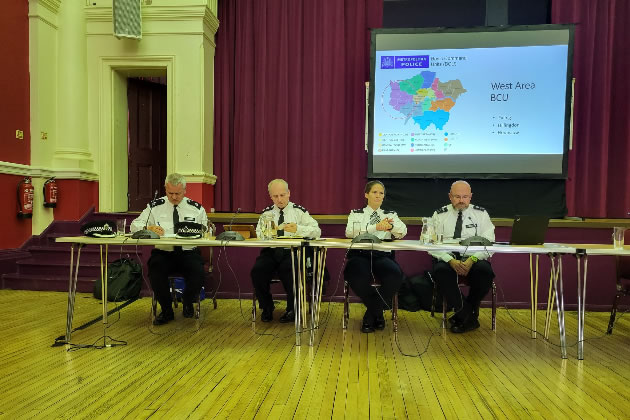 Police officers addressing the meeting in Chiswick Town Hall 