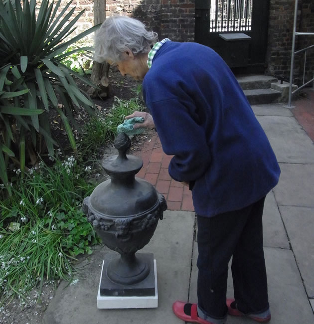 Rosalind Elliott cleaning one of the urns 