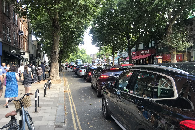 Pedestrians were moving more quickly along Chiswick High Road than motor vehicles