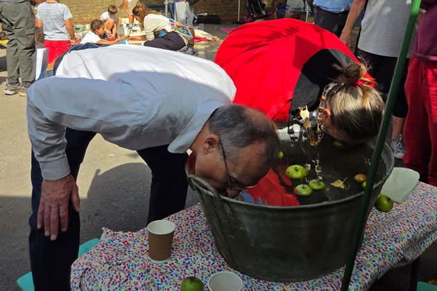 Andy Slaughter MP and the Mayor of Hounslow Amy Croft apple bobbing 