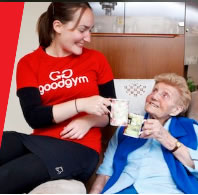 good gym member helps elderly person 