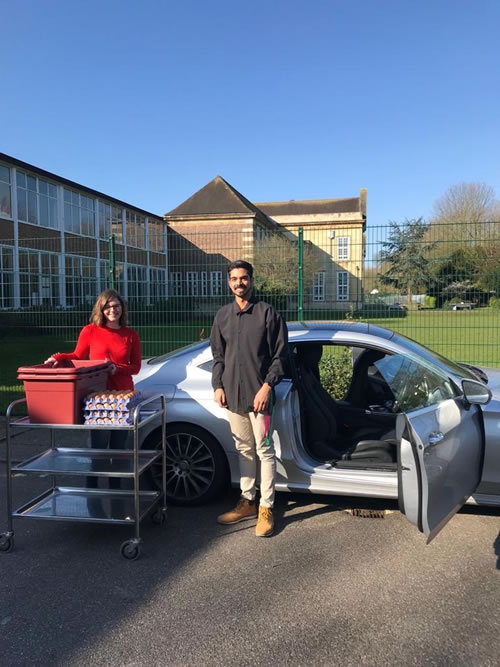 two teachers packing free food 