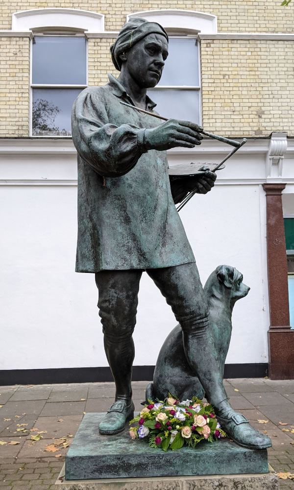 The flowers laid at the base of the William Hogarth statue 
