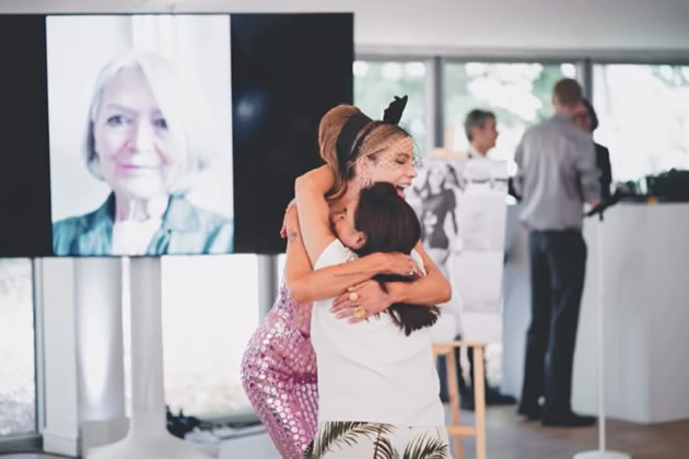Kate Beckinsale hugs a guesy at the celebration at Chiswick House