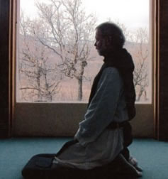person kneeling in prayer