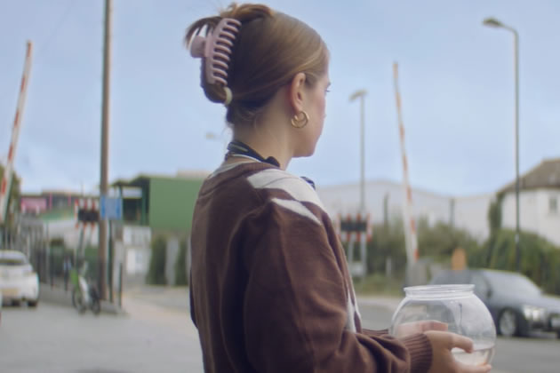 Nadia takes Fernando outside the office by the level crossing on Bollo Lane 